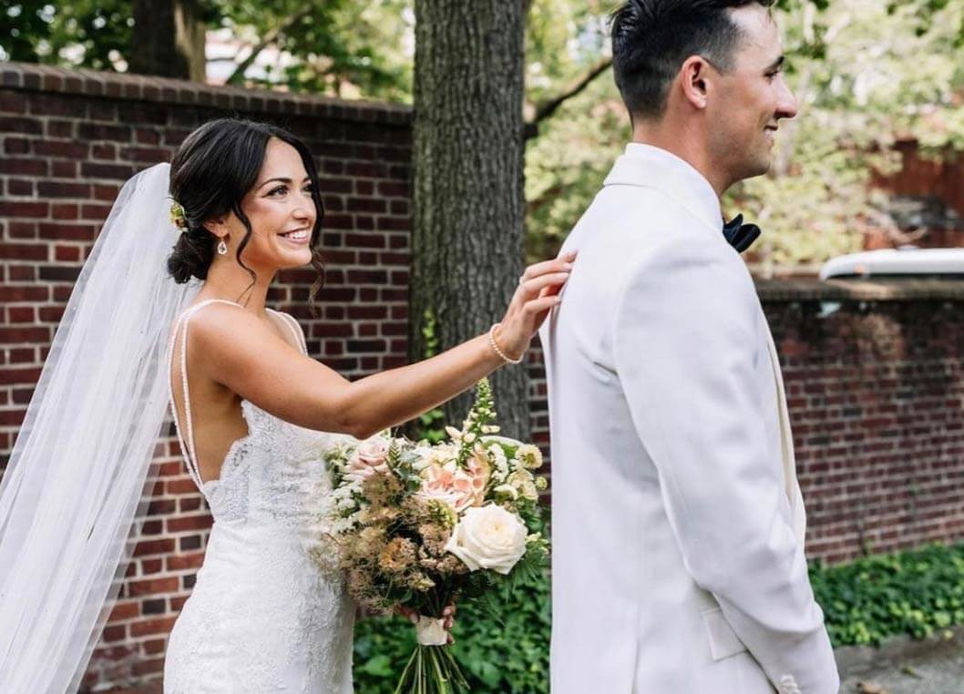 Сouple wearing a white gown and a gray suit