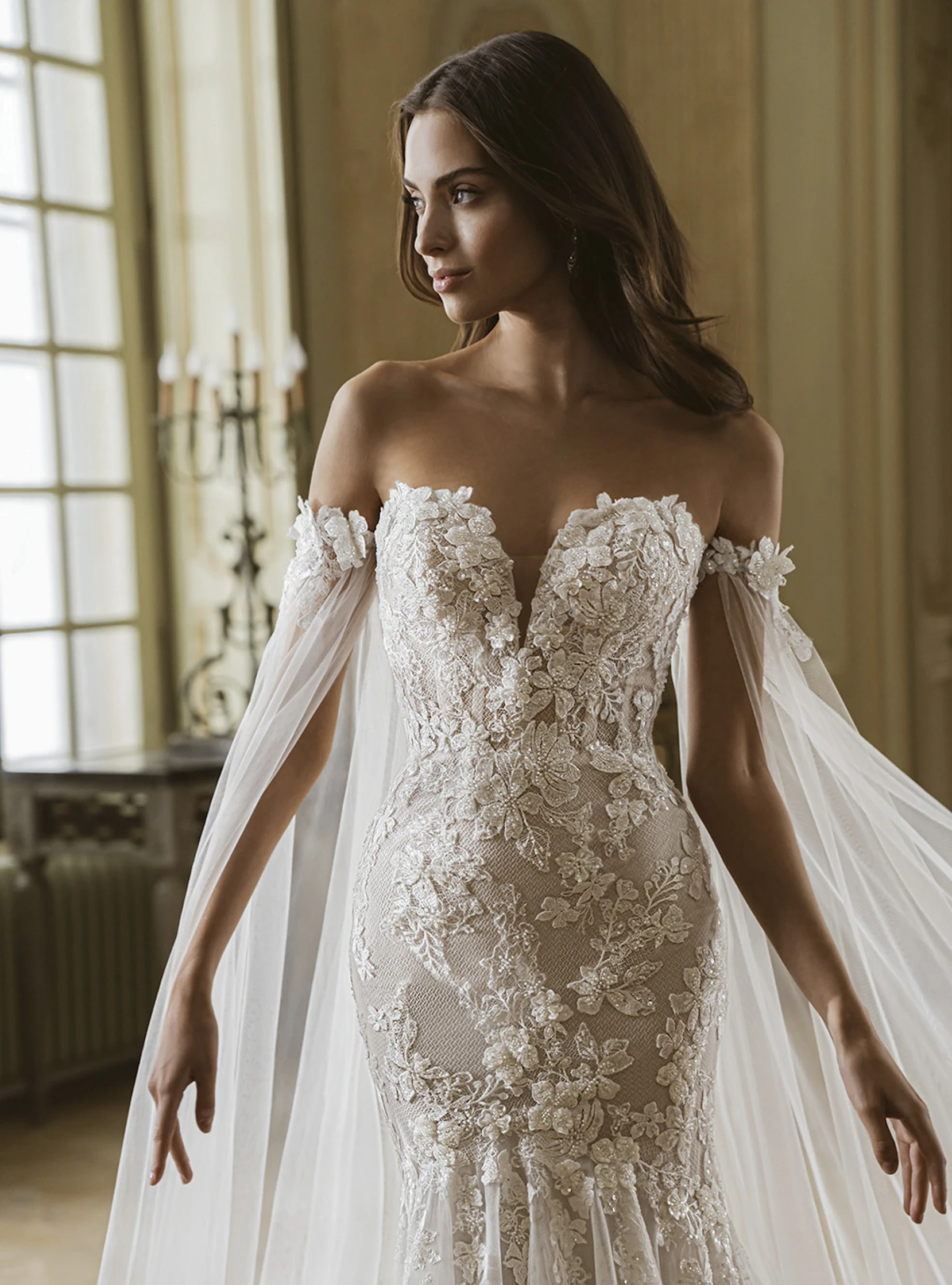 Model wearing a white gown by Elysee