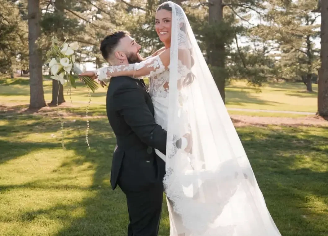 Сouple wearing a white gown and a black suit