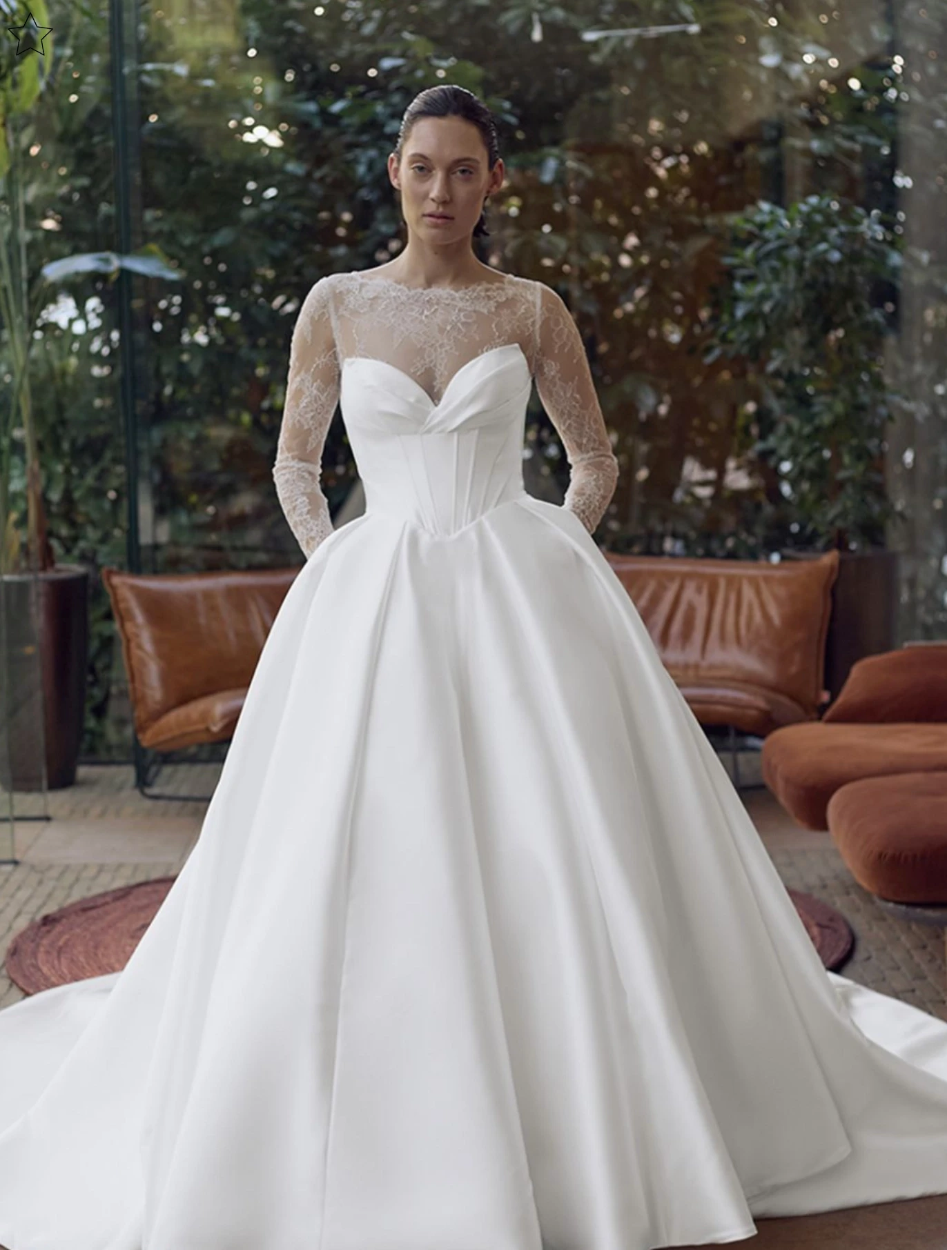 Model wearing a white gown by Elysee