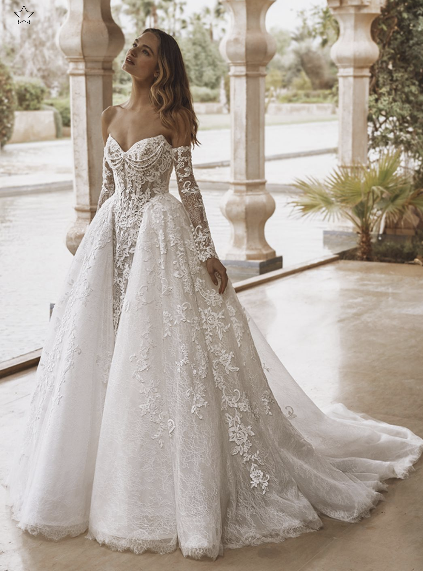 Model wearing a white gown by Enzoani